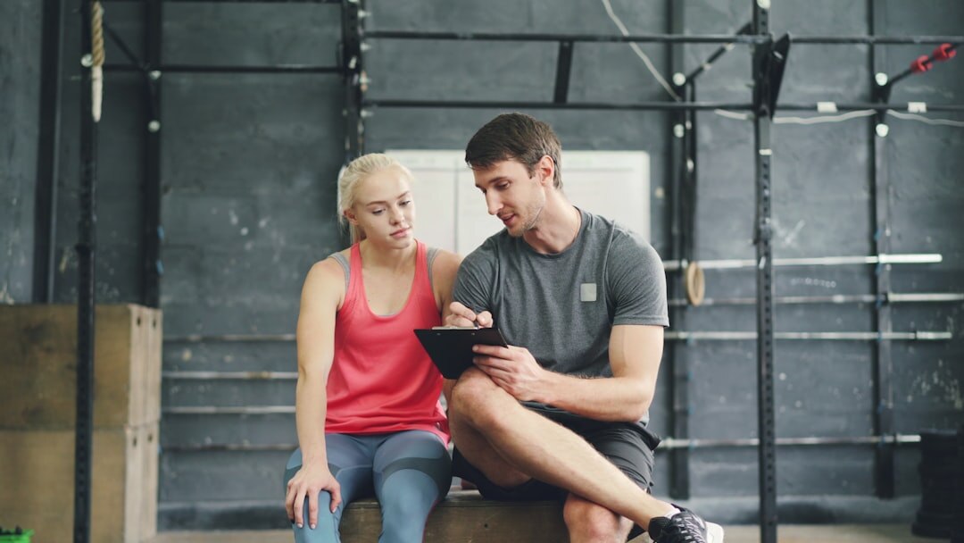 Older woman learning to use a tablet with an instructor