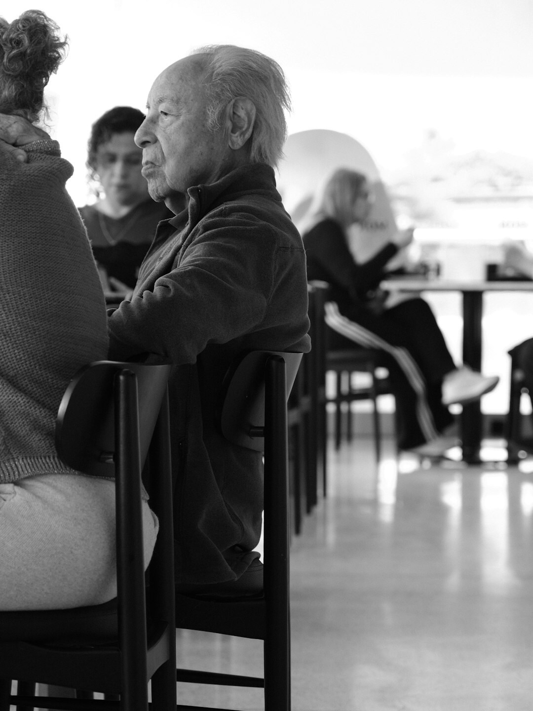 Senior adults chatting and laughing over coffee at a community center