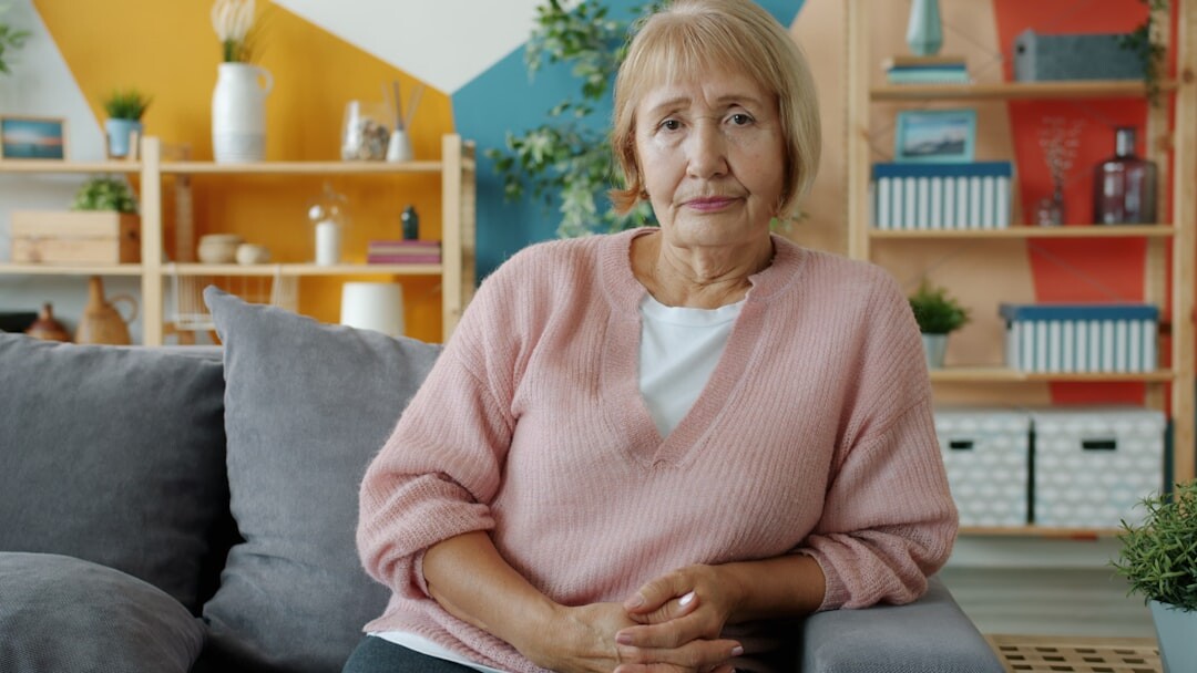 Confident senior woman smiling while holding a tablet