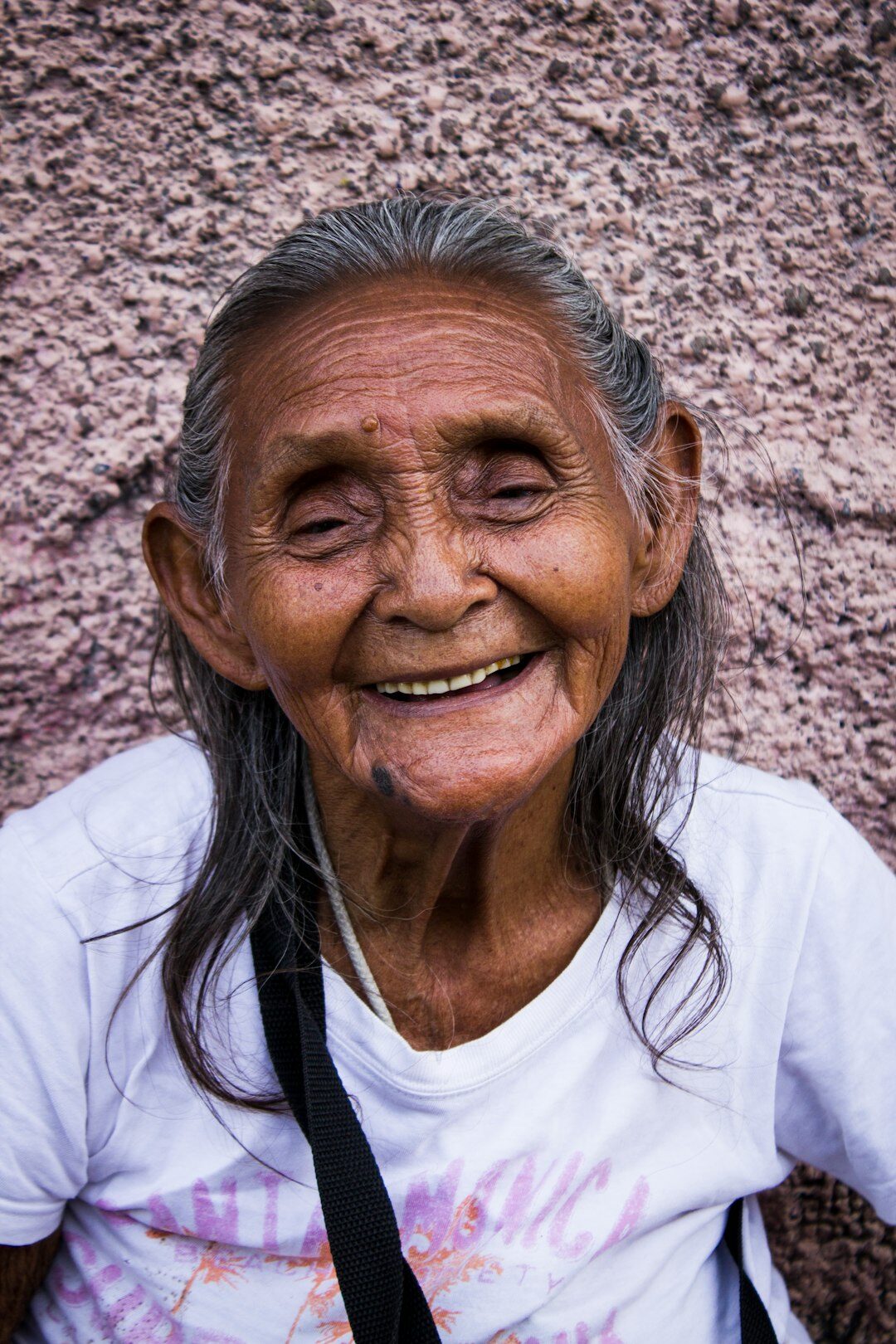Portrait of a smiling senior woman named Elena