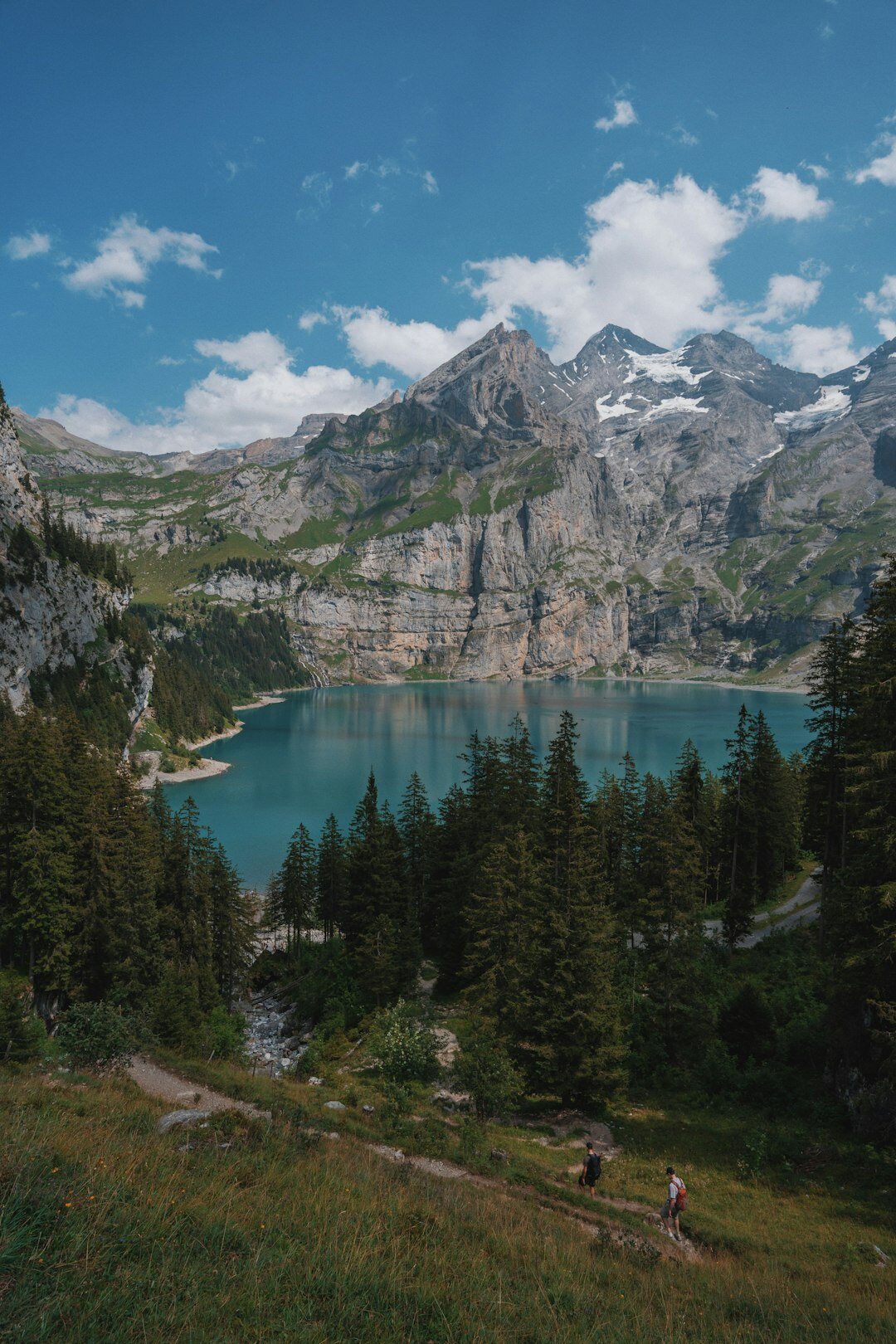 Group of seniors hiking along a lake in Switzerland